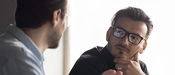 Two men engaged in a serious conversation